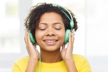 happy woman with headphones listening to music