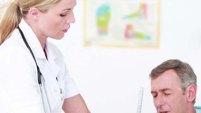 Doctor examining man hand with tools