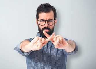 Young hipster man doing NO gesture