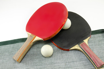 Two table tennis rackets and a net isolated