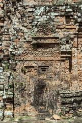 blind door of laterite of a prasat in the archaeological place of the oriental mebon in siam reap, cambodia