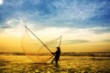 Fishermen fishing in the sea at sunrise in Namdinh, Vietnam.