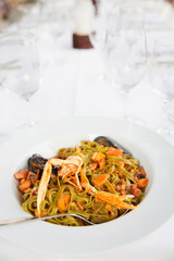 Pasta with crayfish in plate/Mussels and carrots mixed in pasta