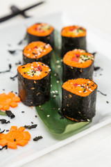 serving raw vegetarian rolls with carrot