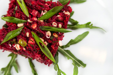 uncooked vegetarian salad with beetroot and greensprouting seed