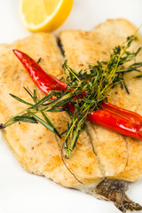 hot roast fillet fish on plate with chili