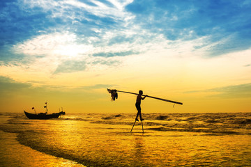 Fishermen fishing in the sea at sunrise in Namdinh, Vietnam.
