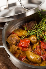 hot roast with tongue and vegetables in metal pan with lid