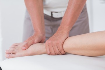 Physiotherapist doing calf massage 