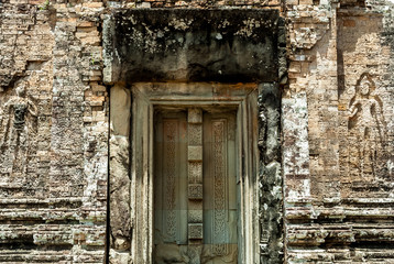 bas-reliefs of devatas and blind door in the archaeological pre rup place in siam reap, cambodia