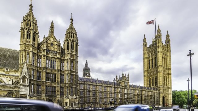 Timelapse view of the House of Parliament in London, also known as Wesminster Palace. The Union jack flies in the wind at the top of Victoria tower