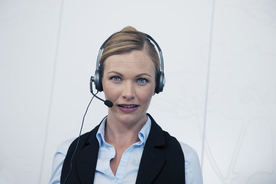 Portrait of a business woman talking on a headset