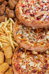 fastfood chicken nuggets, legs, pizzas and fry potatos