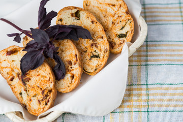 white sliced homemade baguette with dried tomatoes