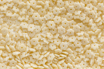 small figured macaroni in background of food