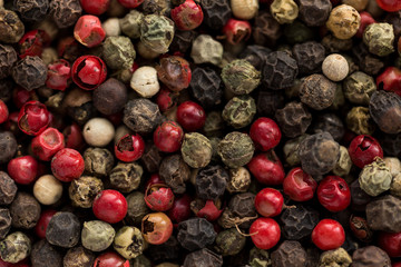 small dry colored peppercorn in food background