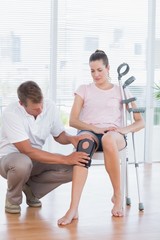 Fototapeta na wymiar Doctor examining his patient knee