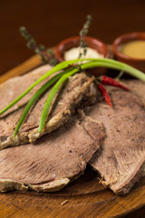 sliced boiled meat presentation on wood board