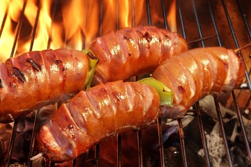 Two Skewers With Sausage On The Hot BBQ Flaming Grill