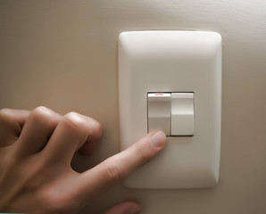 Hand on light switch