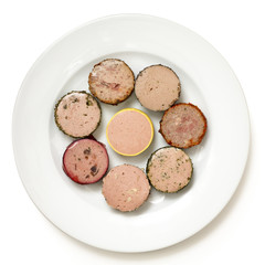 A variety of round pates on plate. Isolated from above.