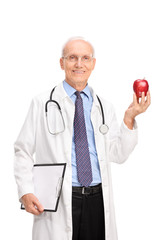 Mature doctor holding a shiny red apple