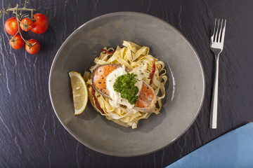 Pasta salmon fresh seasoning pasta with grilled salmon steak in a decor dish