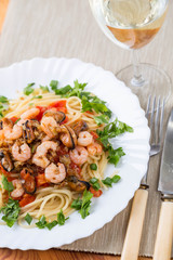 pasta with seafoods and white wine on napkin