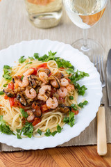 pasta with seafoods and white wine on napkin