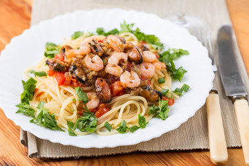 pasta with seafoods and white wine on napkin