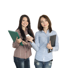 Two cute girls keeping large note pads.
Female students cheerful and smiling jeans casual style dress code keeping large black and green notepads and cell phone on white background