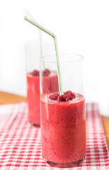 two blended thick smoothie from raspberry with tubule
