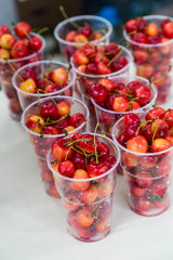 fresh white cherry in plastic glass