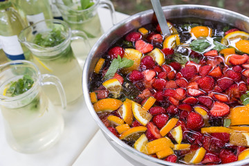 mixed punch with fruits in metal bowl