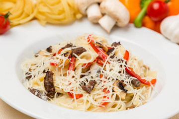 hot pasta with garnish on plate