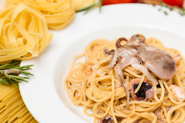 hot pasta with garnish on plate