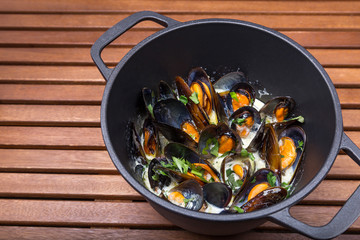 hot mussels with sauce in coast iron