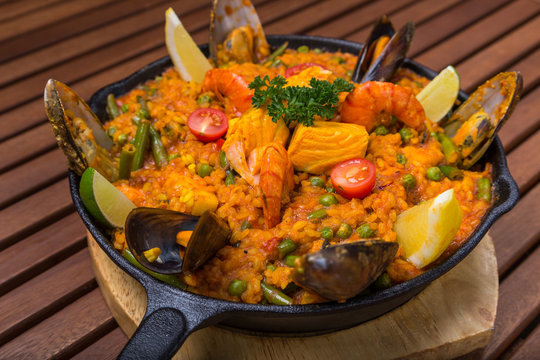 mediterranean paella with seafood in frying pan