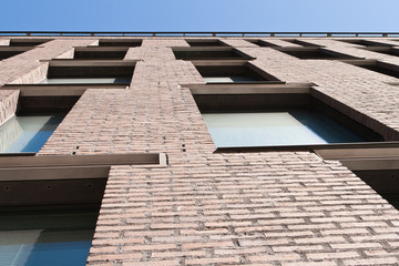 modern windows on brown brick wall