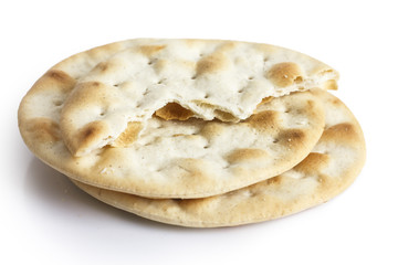 Stack of water biscuits isolated on white. Half with crumbs.