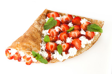 Rolled pancakes with strawberry, sweet cream and mint