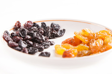 Dried fruit black and withe raisins on plate