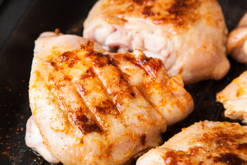 cook chicken  with spice on frying pan