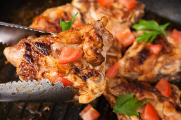 fry chicken piece with spice in tongs