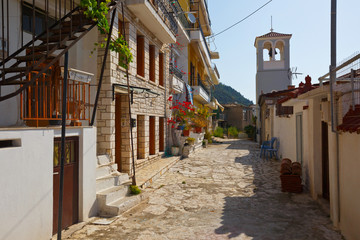 Church bell tower in a street of Nafpaktos village, Greece.