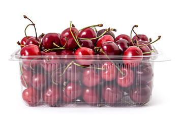 Box or punnet of fresh ripe organic cherries isolated on white background
