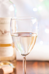 glass and bottle white wine on blink light