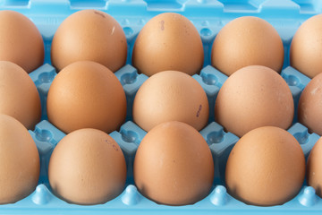 Brown hen's eggs in an opened box