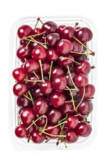 Box or punnet of fresh ripe organic sour cherries isolated on white background