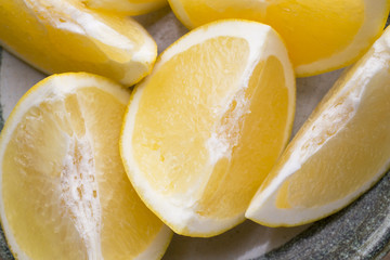 Yellow grapefruit slice on a plate.